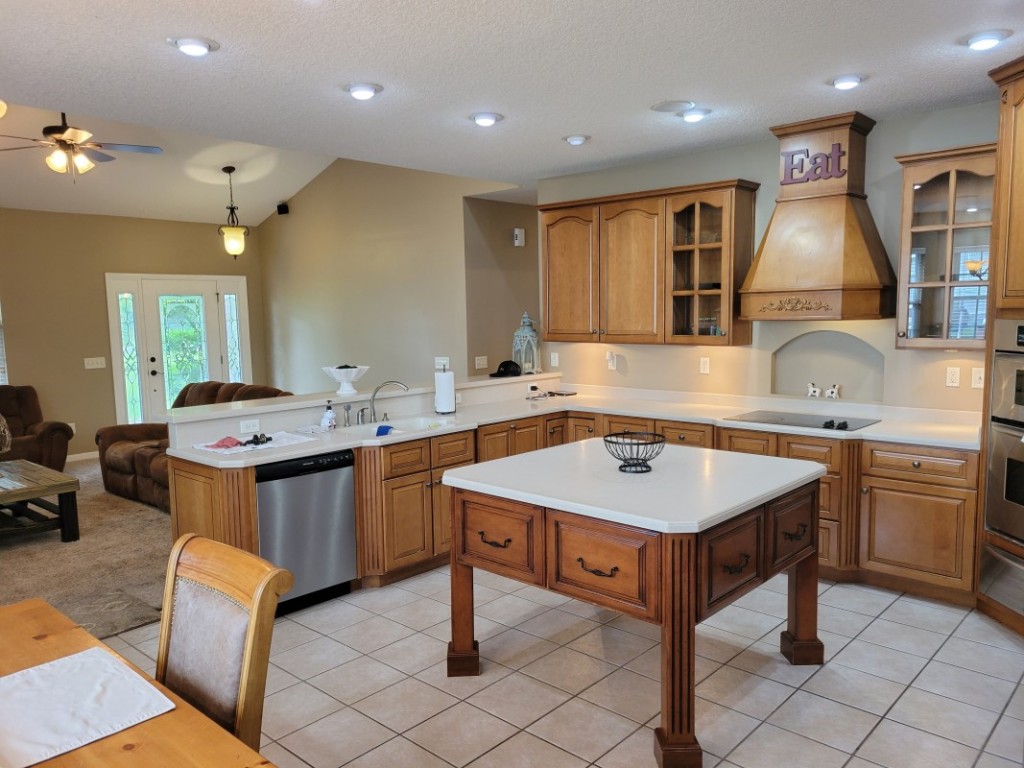 54447 Vikki Road Callahan, FL 32011 - Photo 7 of 24 a kitchen with kitchen island a sink counter top space appliances and cabinets