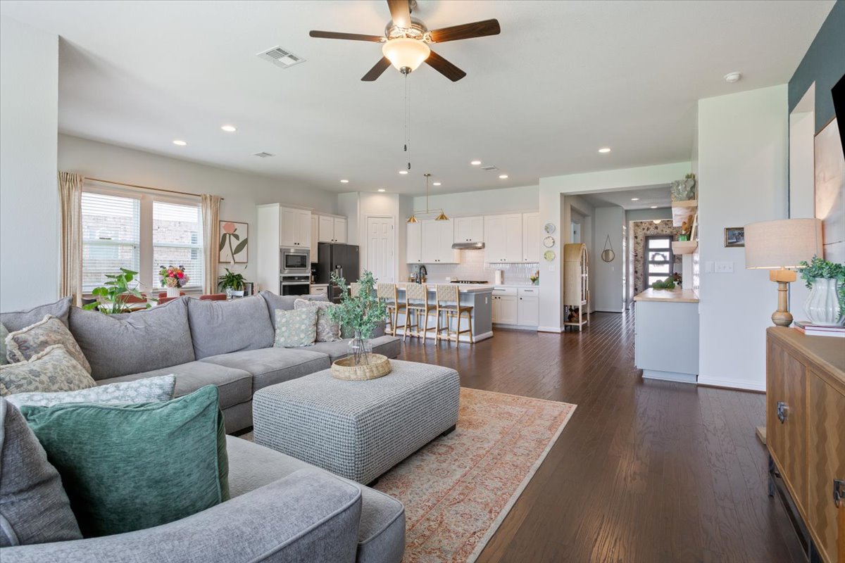 424 Millard Street Georgetown, TX 78628 - Photo 11 of 37 An inviting open-concept layout connects the well-lit living area with a functional, contemporary kitchen.