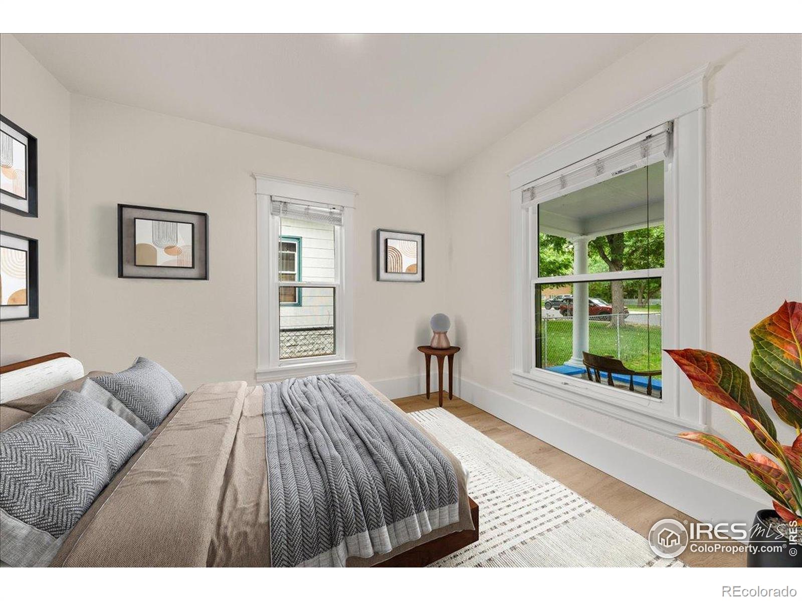 727 Baker Street Longmont, CO 80501 - Photo 12 of 25 a bedroom with a bed and a window with chair