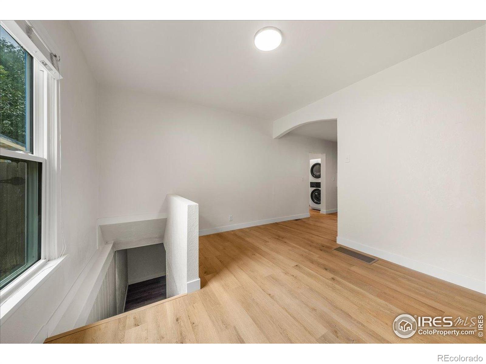 727 Baker Street Longmont, CO 80501 - Photo 15 of 25 a view of empty room with wooden floor