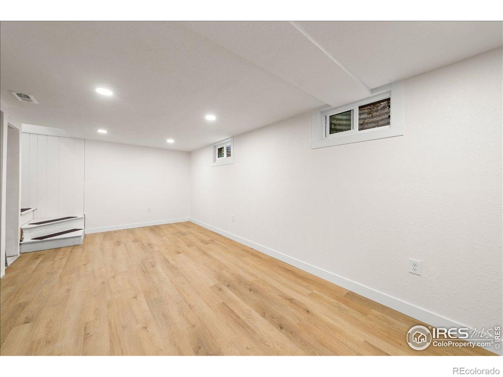 727 Baker Street Longmont, CO 80501 - Photo 19 of 25 a view of empty room with wooden floor