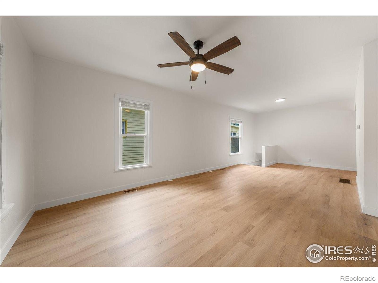 727 Baker Street Longmont, CO 80501 - Photo 6 of 25 a view of a livingroom with a ceiling fan and window