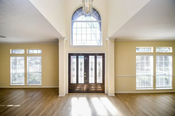 wooden floor in an empty room with a window