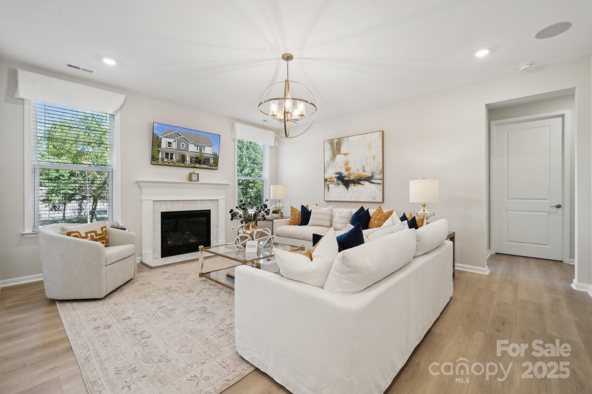 5021 Duval Circle Tega Cay, SC 29708 - Photo 11 of 26 a living room with furniture a fireplace and a large window