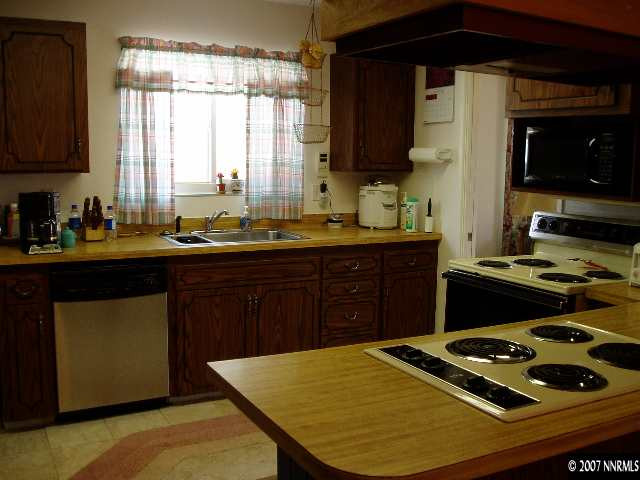 2460 Sutter Circle Reno, NV 89503 - Photo 2 of 8 a kitchen with a sink stove and cabinets