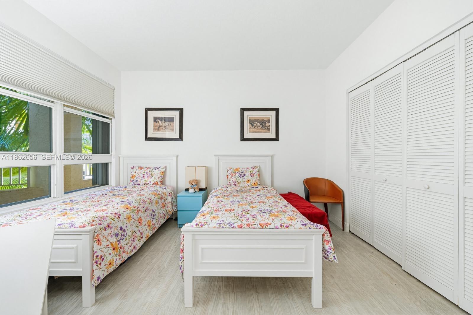 701 Crandon Boulevard, Unit 302 Key Biscayne, FL 33149 - Photo 15 of 26 a bedroom with bed and a baby crib