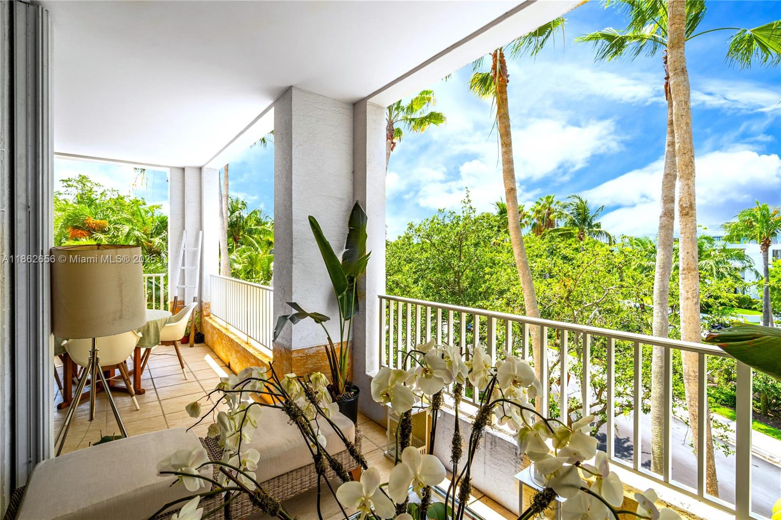 701 Crandon Boulevard, Unit 302 Key Biscayne, FL 33149 - Photo 18 of 46 a view of a porch with chairs and backyard
