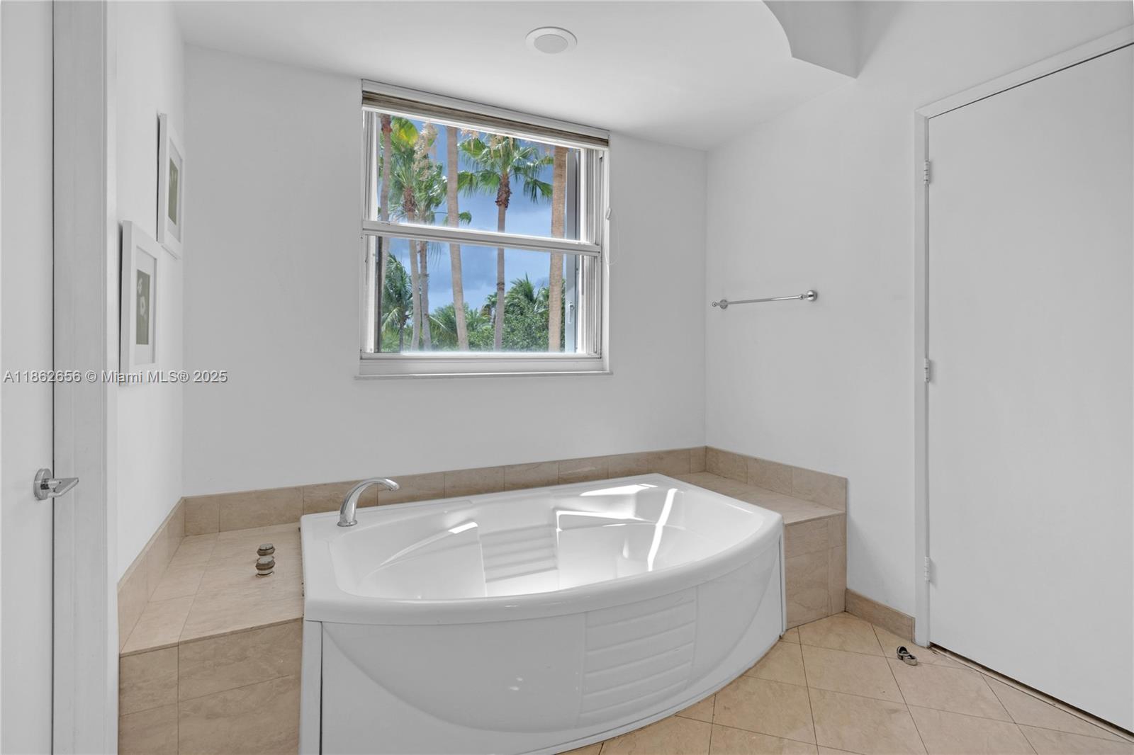 701 Crandon Boulevard, Unit 302 Key Biscayne, FL 33149 - Photo 21 of 46 a white bath tub sitting next to a window