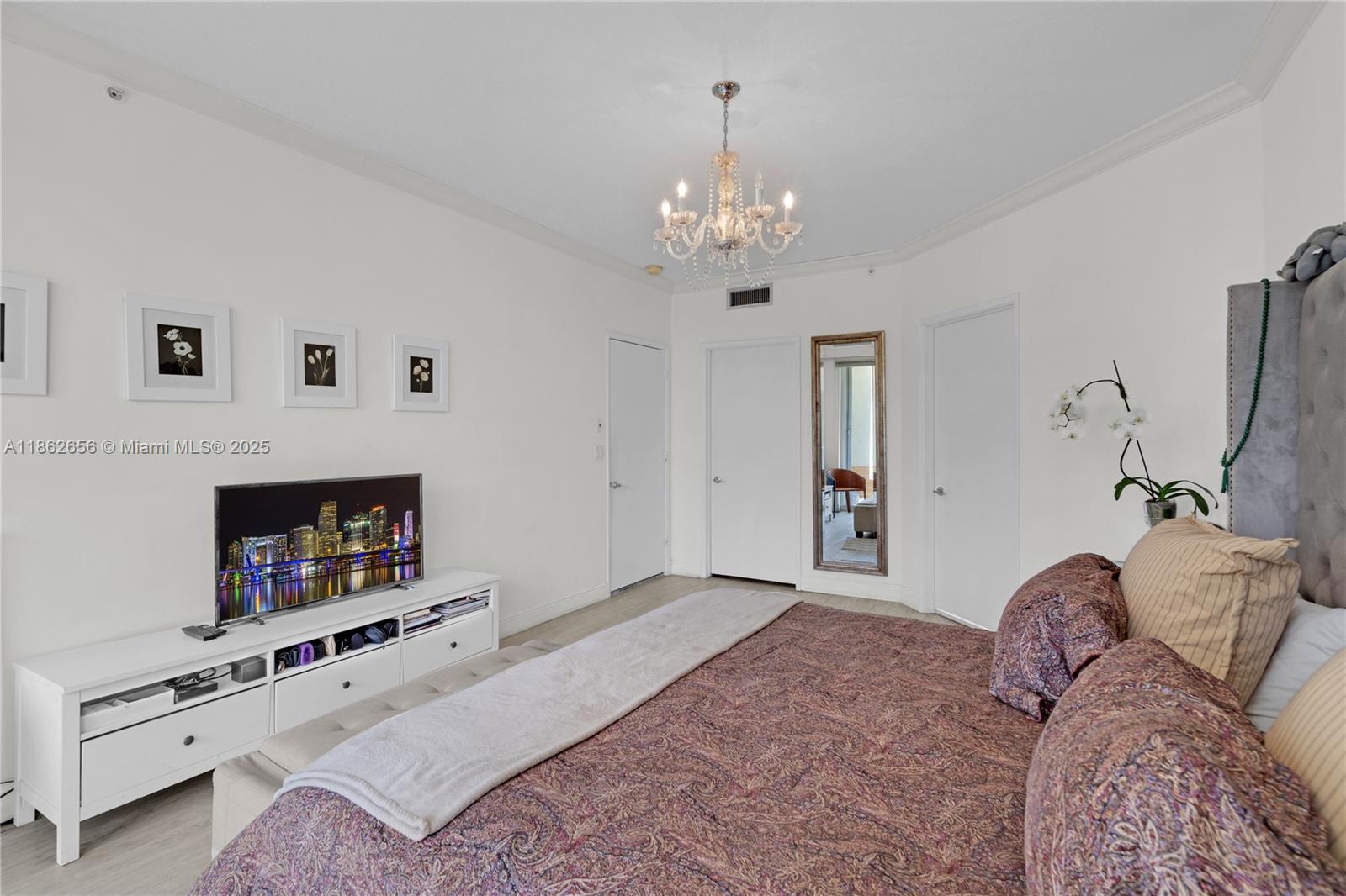 701 Crandon Boulevard, Unit 302 Key Biscayne, FL 33149 - Photo 24 of 46 a bedroom with a bed and a fireplace