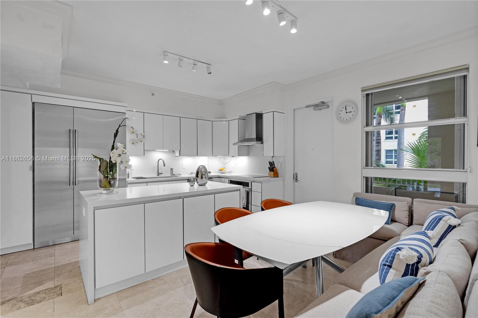 701 Crandon Boulevard, Unit 302 Key Biscayne, FL 33149 - Photo 29 of 46 a kitchen with stainless steel appliances granite countertop a sink a stove a kitchen island with a dining table and chairs