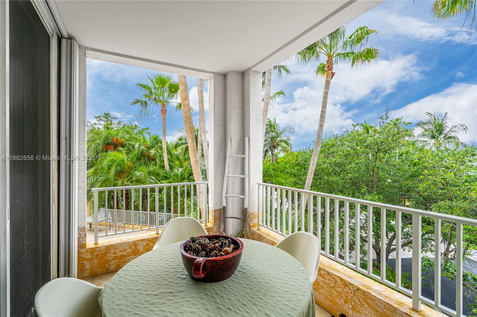 701 Crandon Boulevard, Unit 302 Key Biscayne, FL 33149 - Photo 35 of 46 a view of a balcony with chair and potted plants