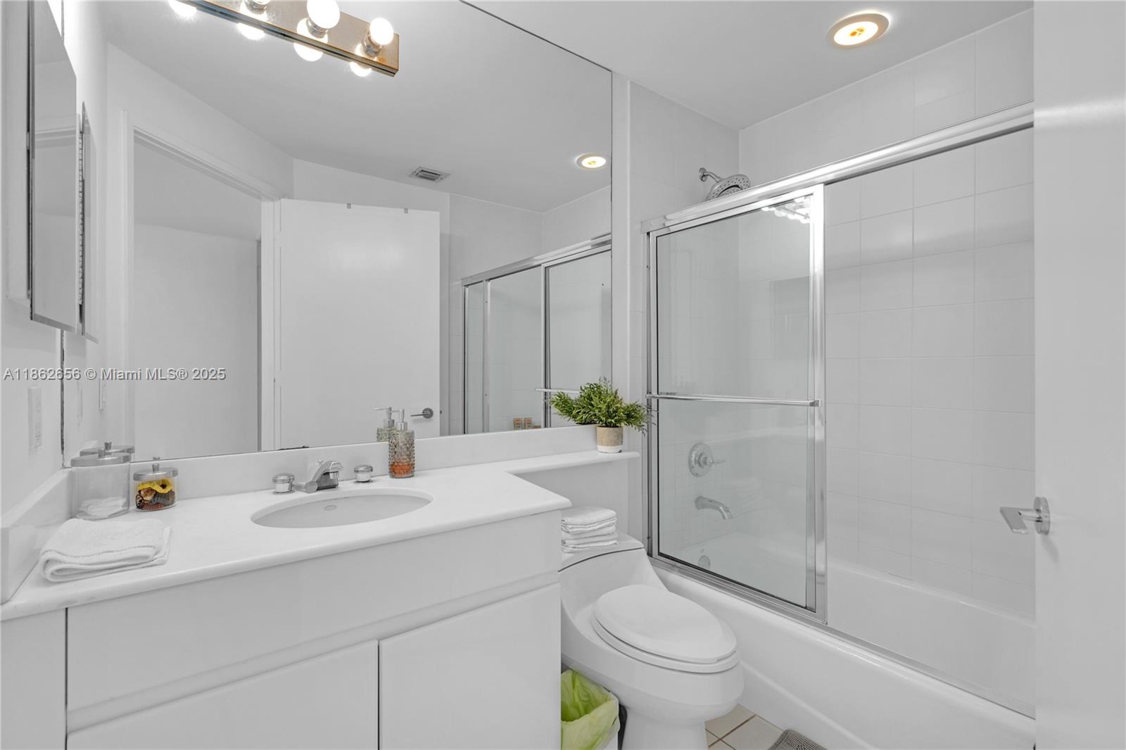 701 Crandon Boulevard, Unit 302 Key Biscayne, FL 33149 - Photo 37 of 46 a bathroom with a sink a toilet and shower