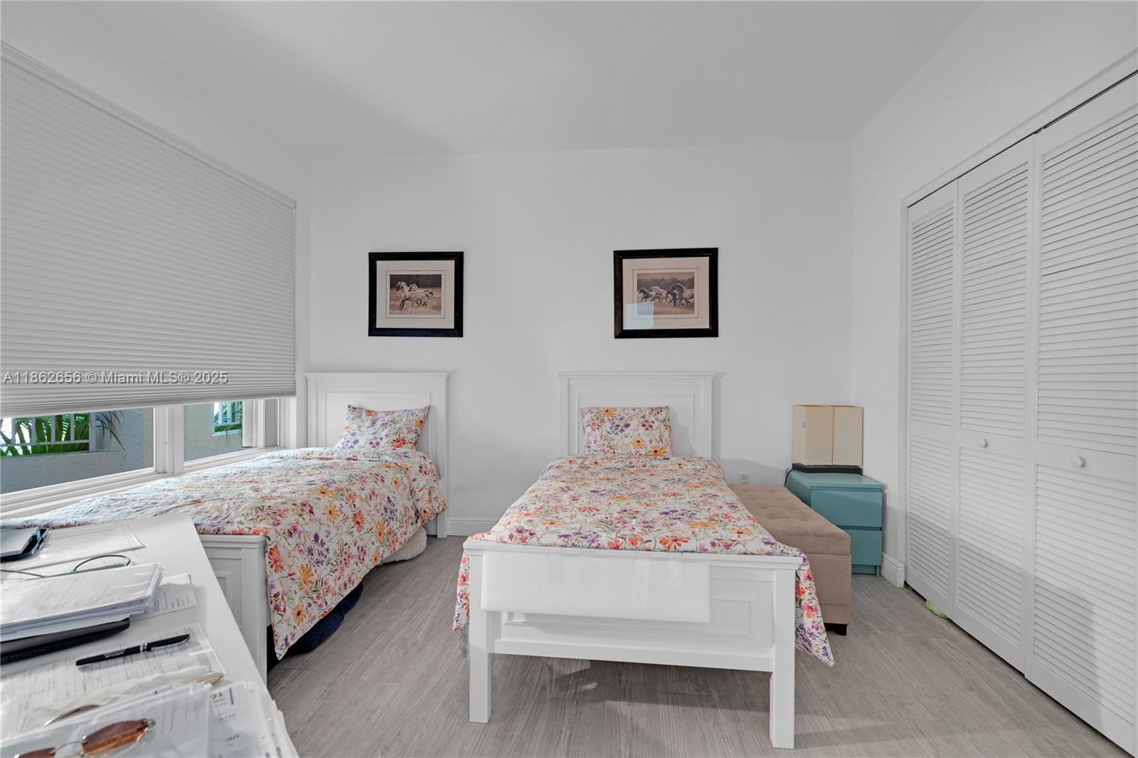 701 Crandon Boulevard, Unit 302 Key Biscayne, FL 33149 - Photo 39 of 46 a bedroom with two beds and a table