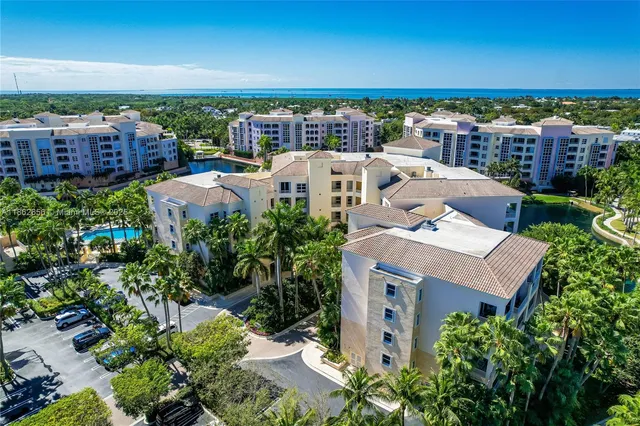 an aerial view of a house with yard and ocean view