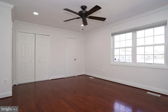 a view of a livingroom with a ceiling fan and window