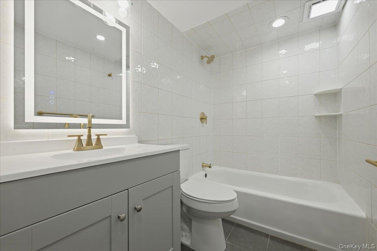 84 North Fordham Road Hicksville, NY 11801 - Photo 23 of 28 a bathroom with a sink a toilet and shower