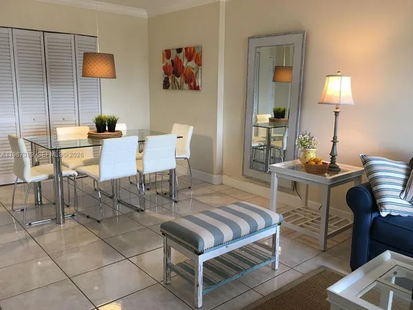 a living room with furniture and a lamp