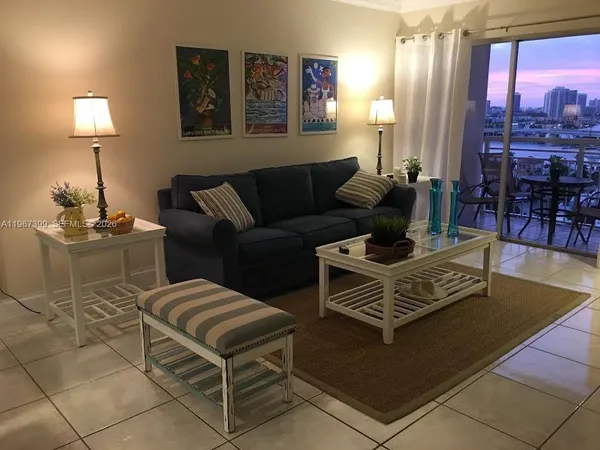 a living room with furniture and a lamp