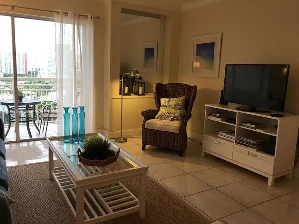 a living room with furniture and a flat screen tv