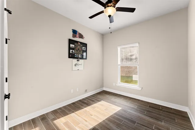 a view of an empty room with wooden floor