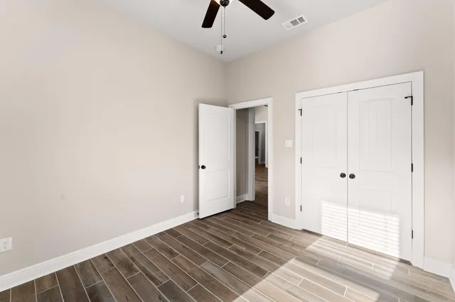 a large kitchen with stainless steel appliances granite countertop a sink a stove and a refrigerator