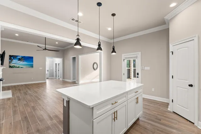 a kitchen with white cabinets appliances and sink