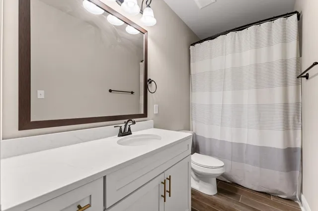 an empty room with a window and a ceiling fan