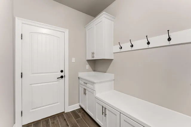 a view of empty room with fireplace and windows