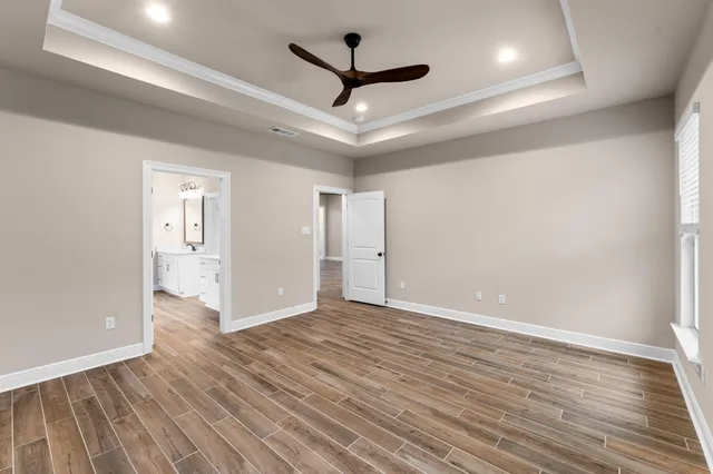 a spacious bathroom with a double vanity sink a mirror and a shower