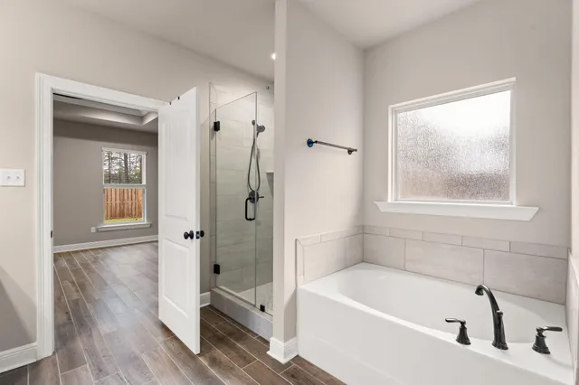 a spacious bathroom with double vanity a mirror and a sink