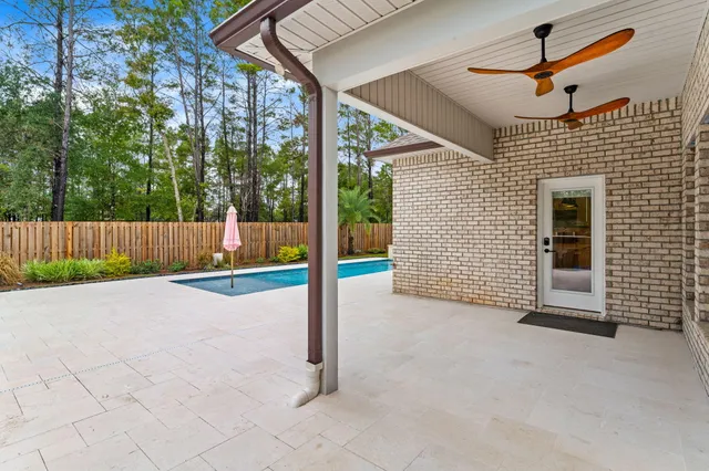 a swimming pool with a bench in the background
