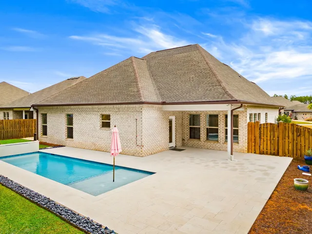 a view of house with swimming pool outdoor seating yard