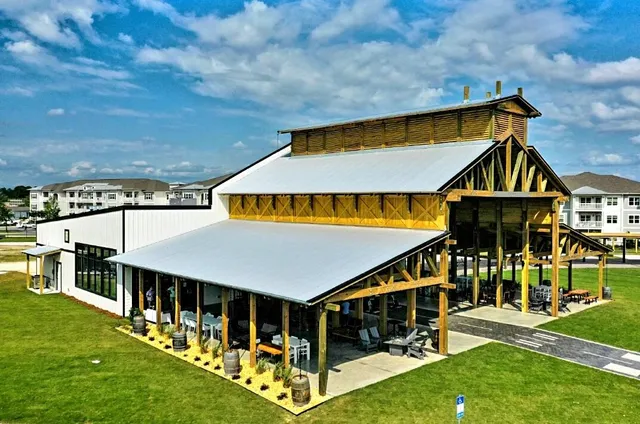 an aerial view of a house with outdoor space and swimming pool