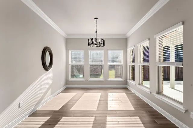 a view of a room with wooden floor windows and chandelier