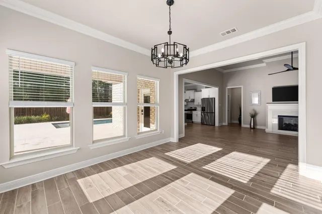 a view of a kitchen with wooden floor and a ceiling fan