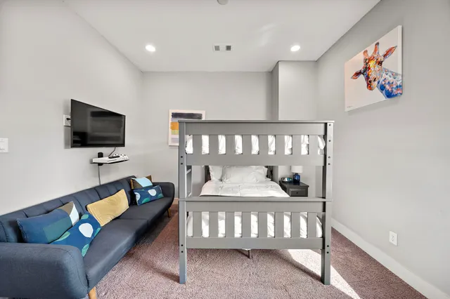 a bedroom with furniture and a flat screen tv