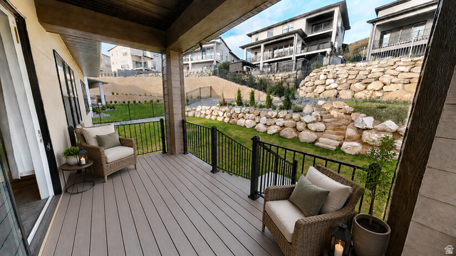 5502 North Valley View Road Lehi, UT 84048 - Photo 31 of 33 Covered patio featuring composite decking, black metal railings, and a wood-paneled ceiling