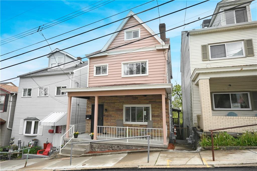 1411 Eleanor Street Pittsburgh, PA 15210 - Photo 1 of 23 a front view of a house with a garage