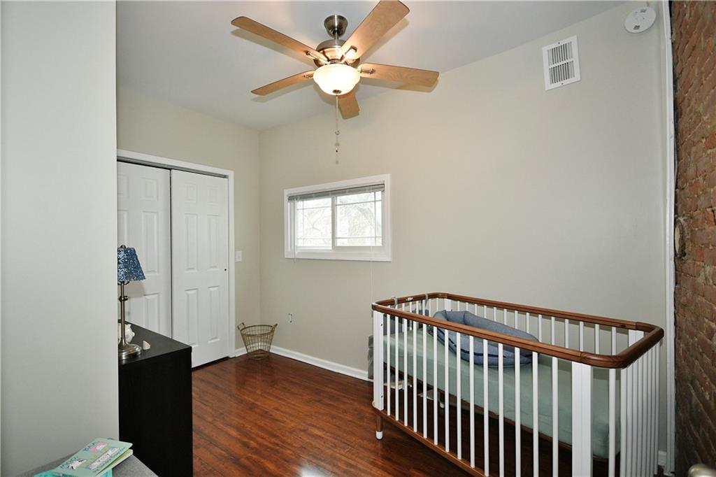 1411 Eleanor Street Pittsburgh, PA 15210 - Photo 15 of 23 a view of a hallway with wooden floor and a chandelier fan