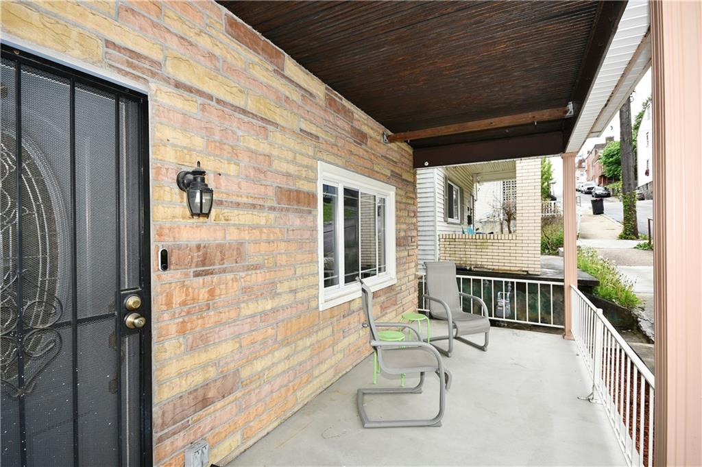 1411 Eleanor Street Pittsburgh, PA 15210 - Photo 2 of 23 a balcony with table and chairs