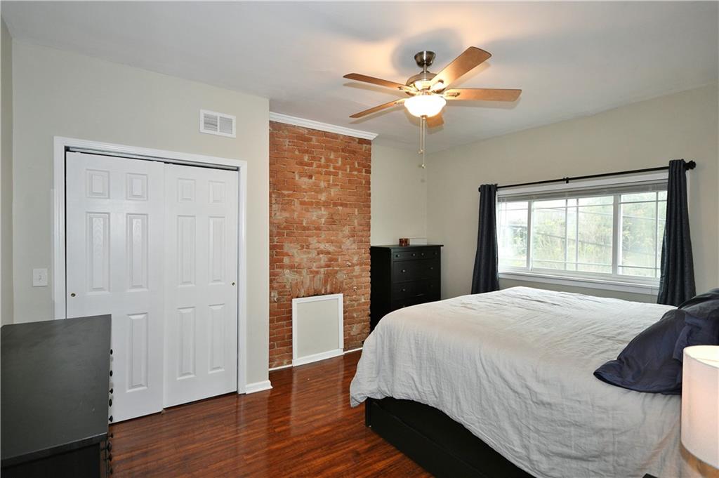 1411 Eleanor Street Pittsburgh, PA 15210 - Photo 10 of 23 a bedroom with a bed and a window