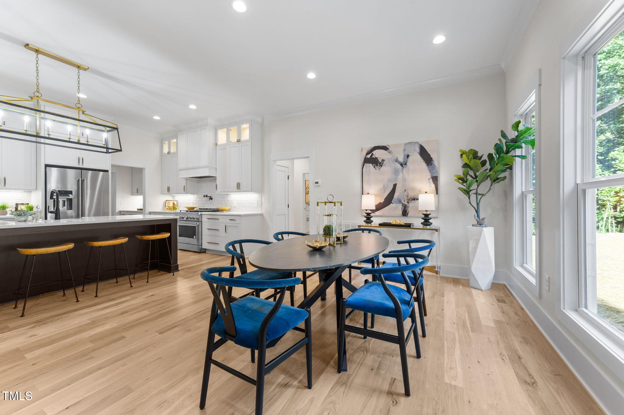 2817 Silk Hope Gum Springs Road Pittsboro, NC 27312 - Photo 14 of 56 a view of a dining room with furniture window and wooden floor