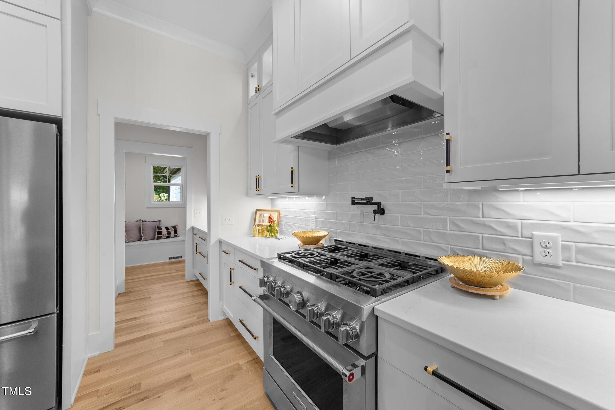 2817 Silk Hope Gum Springs Road Pittsboro, NC 27312 - Photo 17 of 56 a kitchen with stainless steel appliances granite countertop a stove and a wooden floors