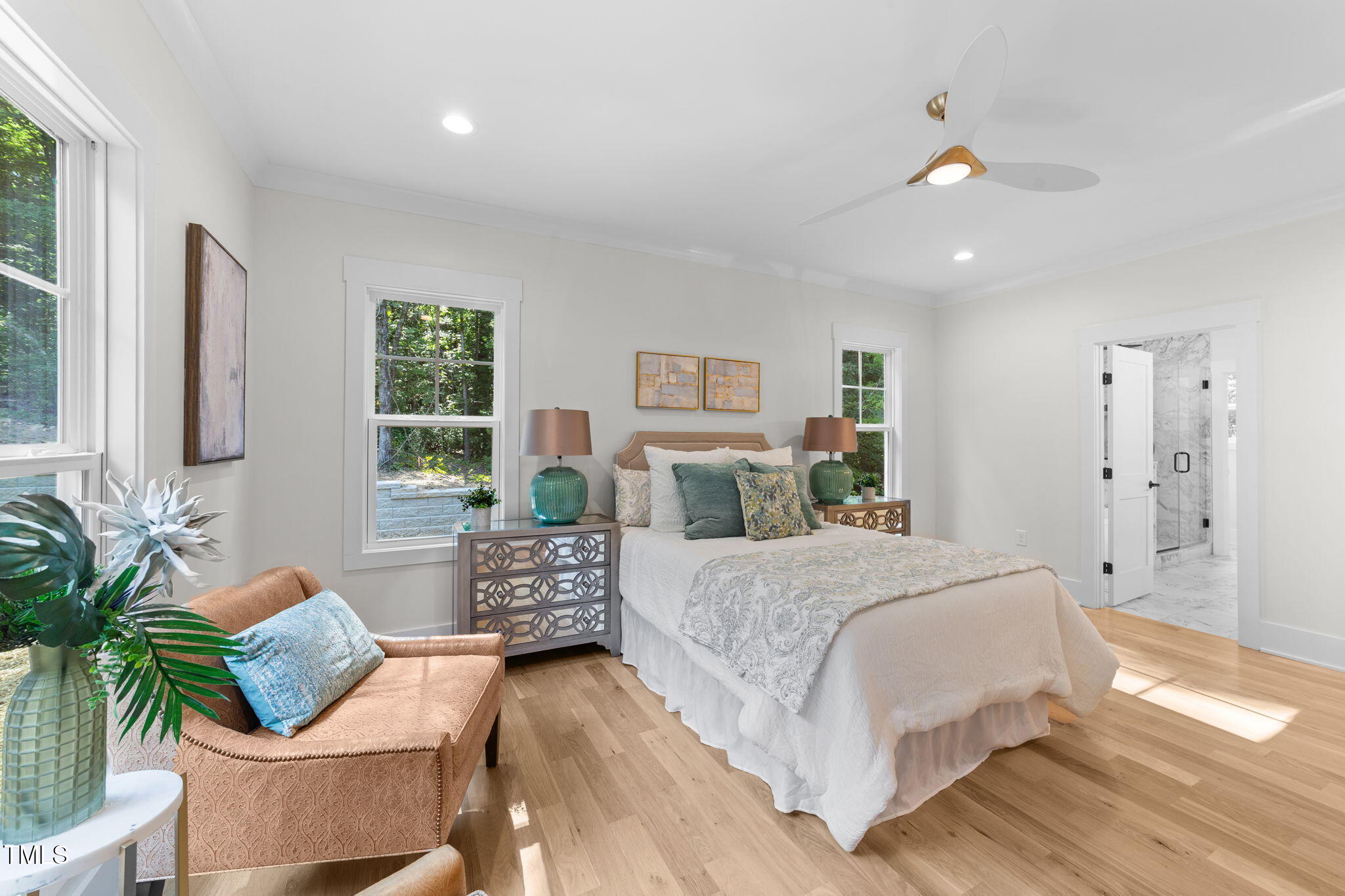 2817 Silk Hope Gum Springs Road Pittsboro, NC 27312 - Photo 20 of 56 a bedroom with a large bed and a potted plant