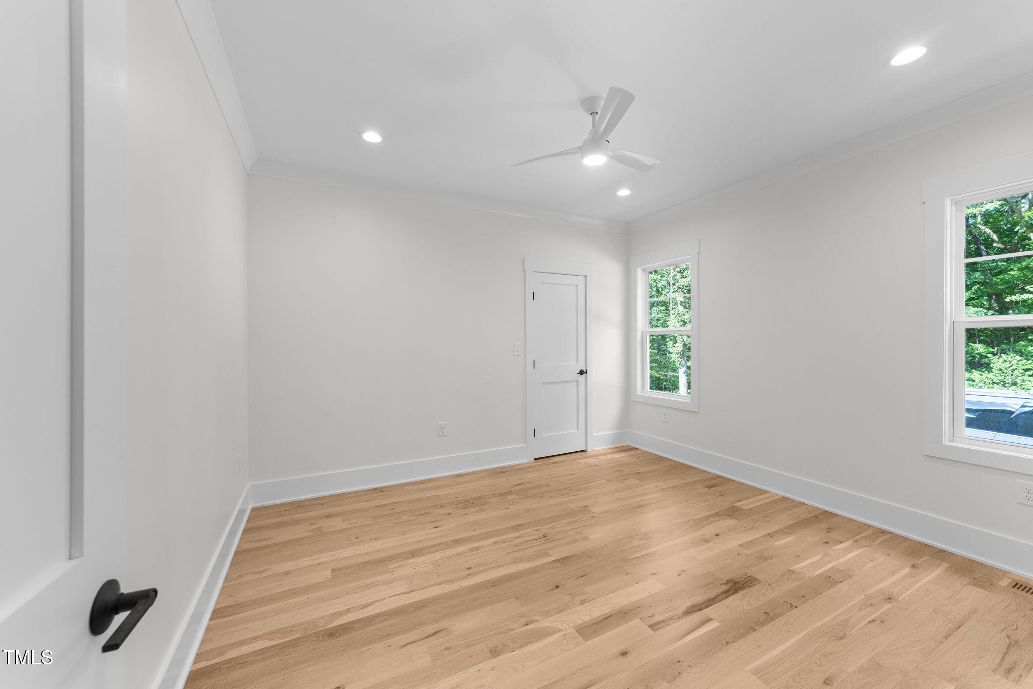 2817 Silk Hope Gum Springs Road Pittsboro, NC 27312 - Photo 26 of 56 an empty room with wooden floor and windows