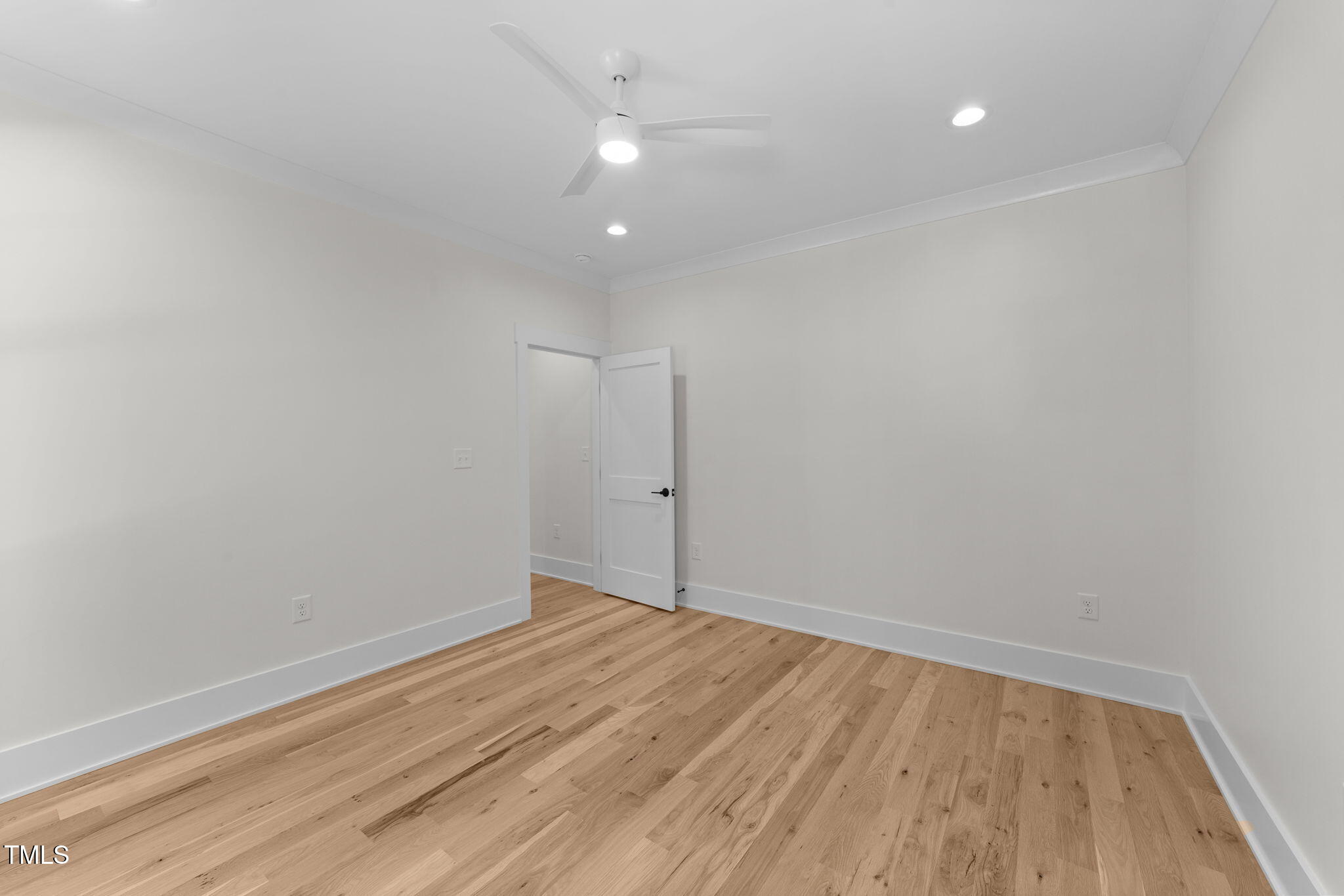 2817 Silk Hope Gum Springs Road Pittsboro, NC 27312 - Photo 33 of 56 an empty room with wooden floor and windows
