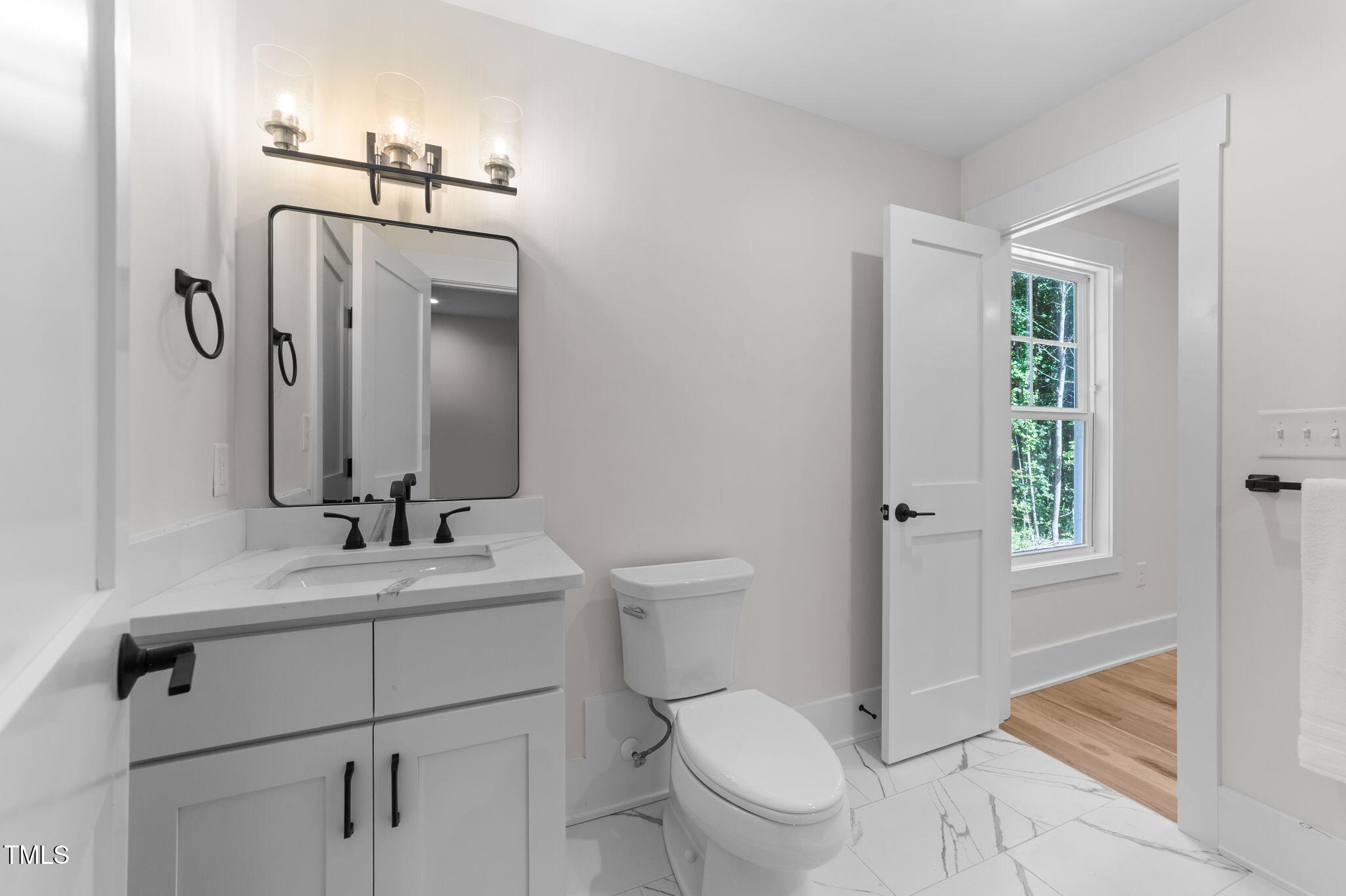 2817 Silk Hope Gum Springs Road Pittsboro, NC 27312 - Photo 34 of 56 a bathroom with a toilet a sink a vanity and mirror