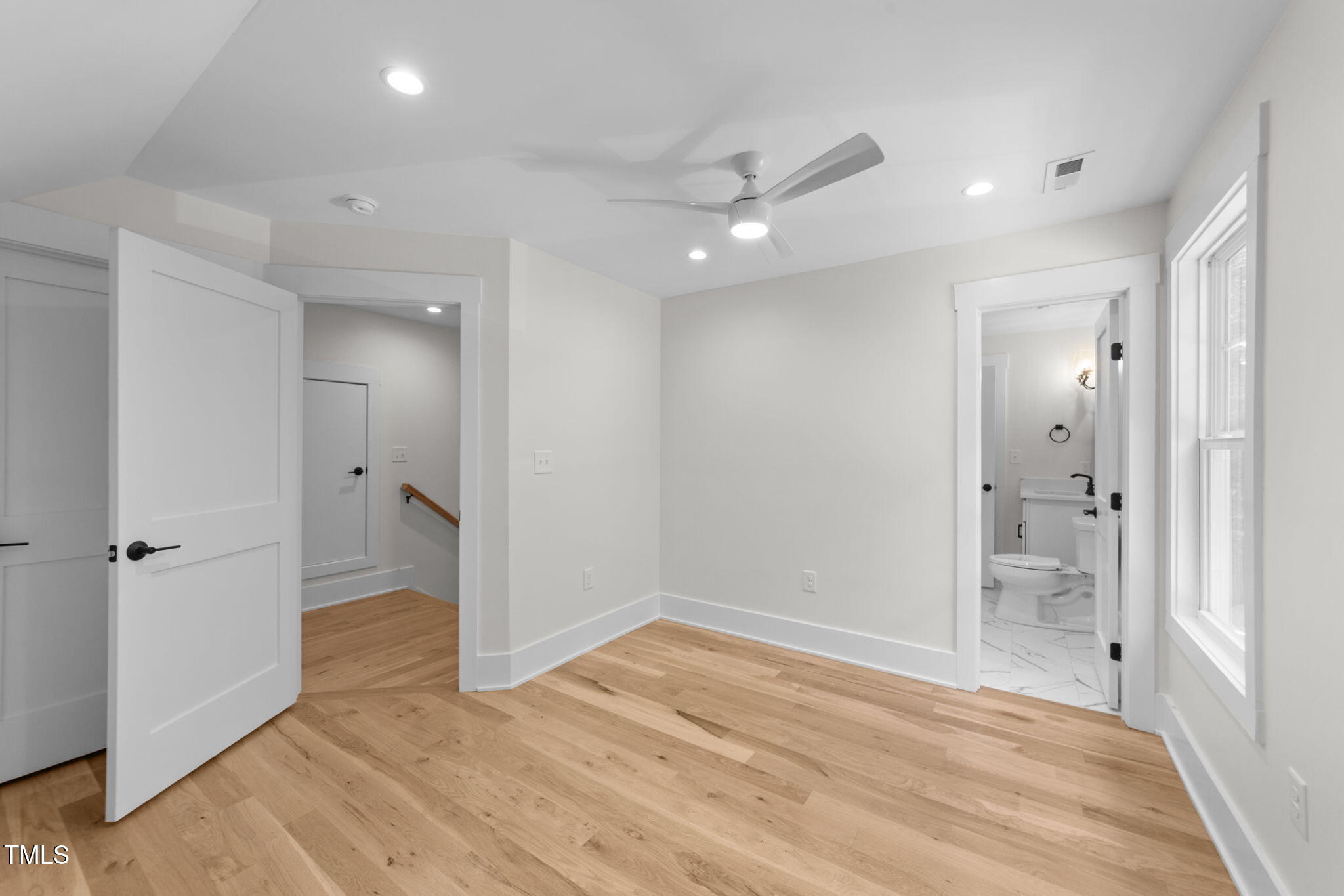 2817 Silk Hope Gum Springs Road Pittsboro, NC 27312 - Photo 35 of 56 wooden floor in an empty room with a bathroom
