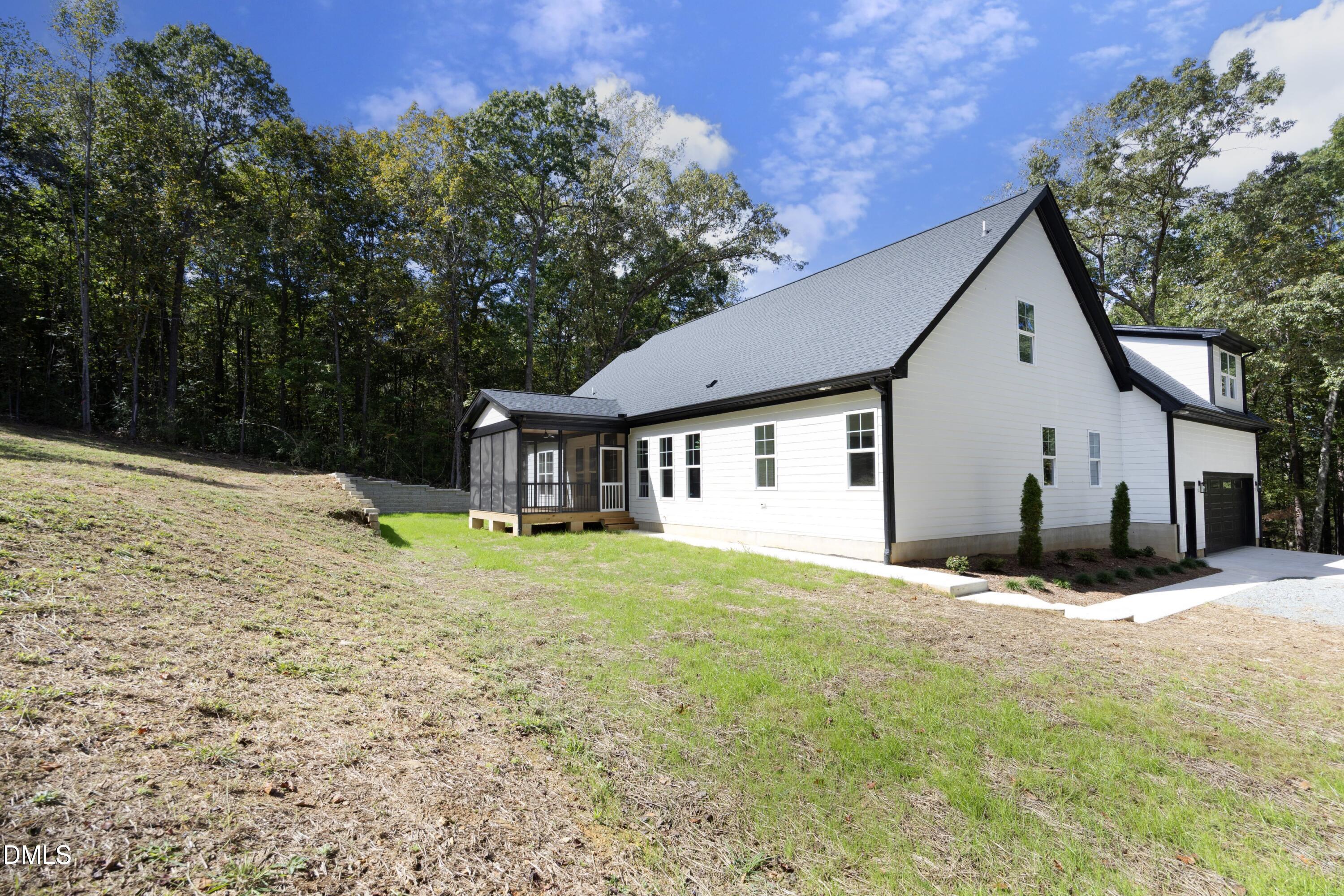 2817 Silk Hope Gum Springs Road Pittsboro, NC 27312 - Photo 43 of 56 a view of a house with a yard and large tree