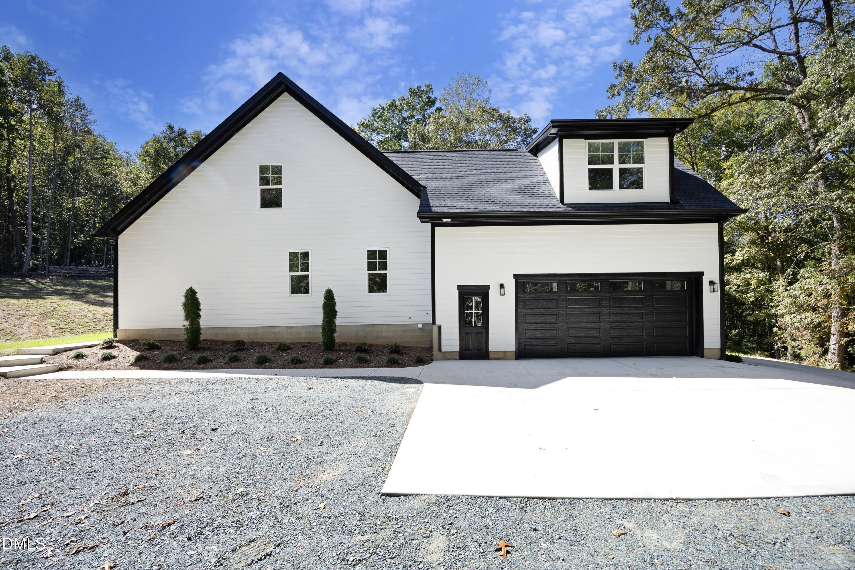 2817 Silk Hope Gum Springs Road Pittsboro, NC 27312 - Photo 45 of 56 a view of a house with backyard and trees